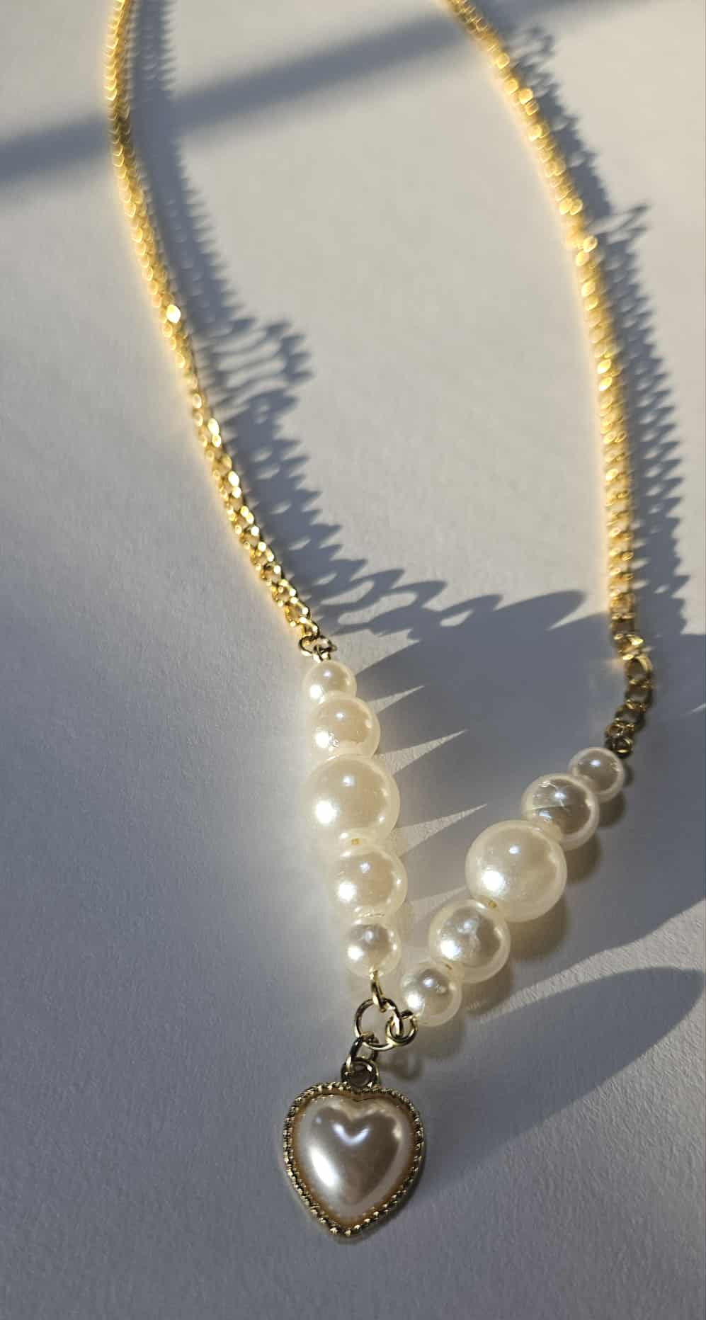 Gold-plated pearl necklace with a matching pearl heart-shaped pendant.