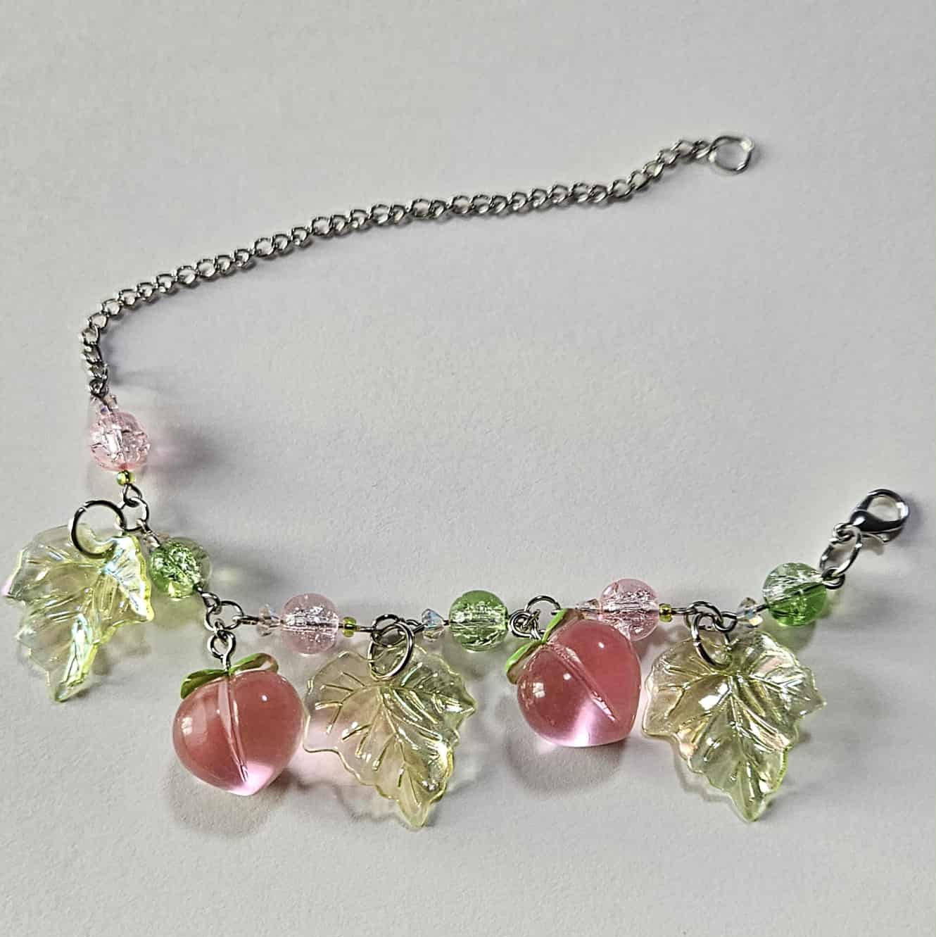 A peach inspired Charm bracelet! Silver-plated.